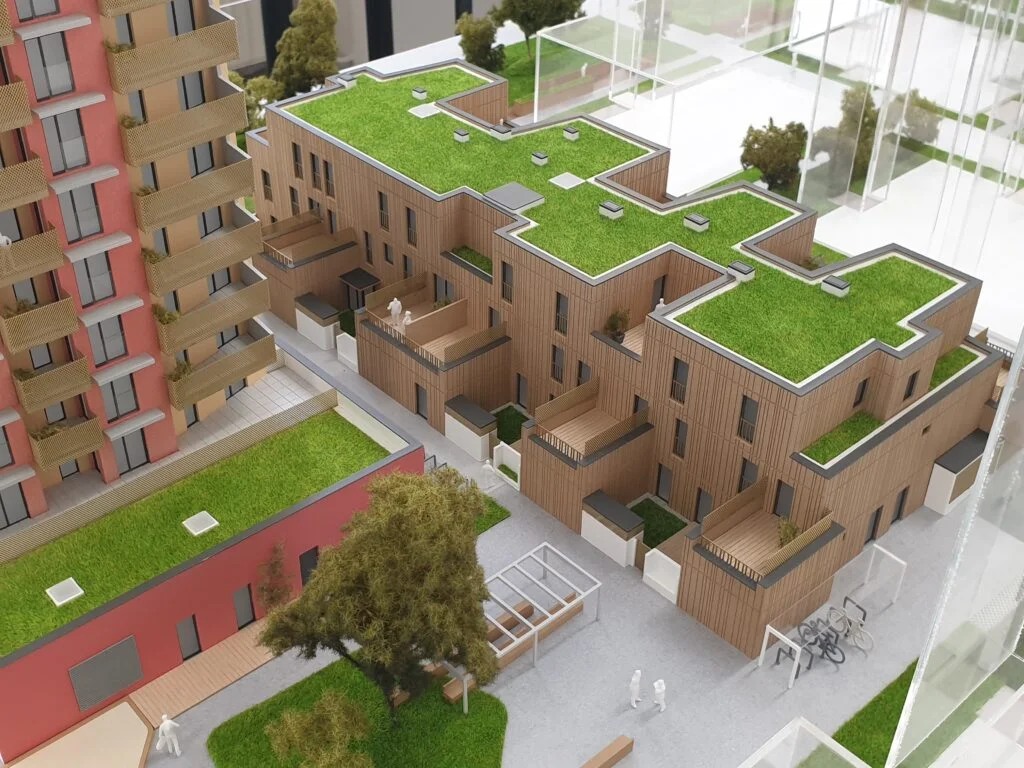 Architekturmodell einer Wohnanlage – Holzfassade mit Balkonen und begrünten Flachdächern, detailreich dargestellt.