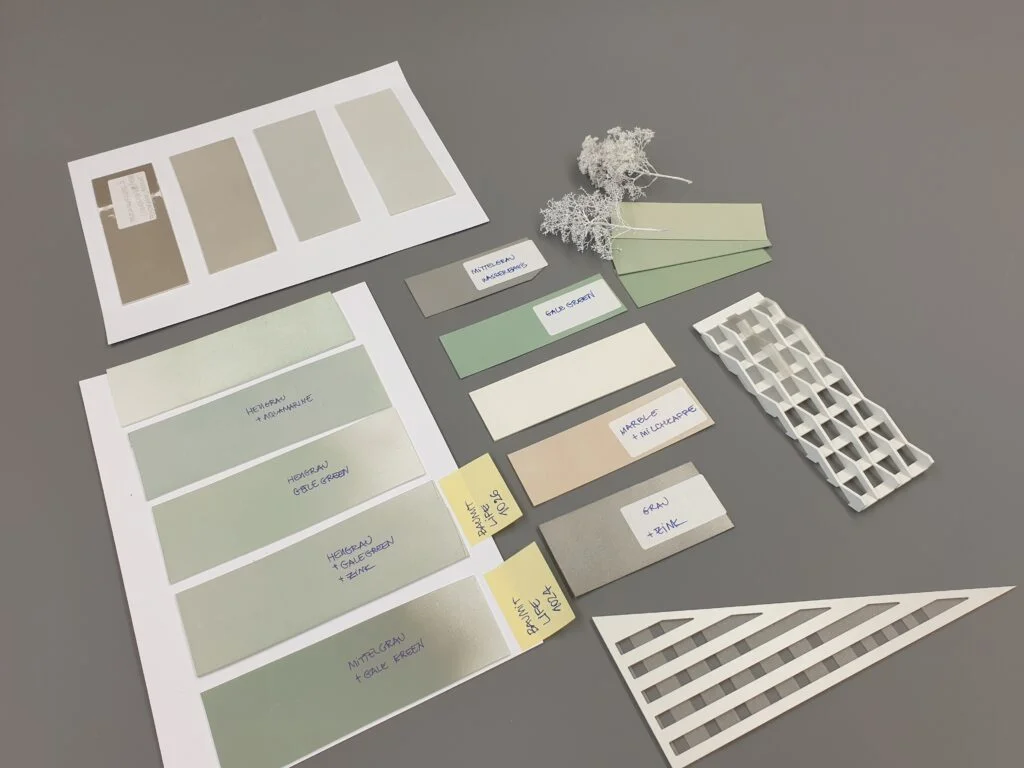 Bemusterungsmodell Fassade – Farb- und Materialtests in Grau und Grün, mit Mustertafeln und Modellteilen.