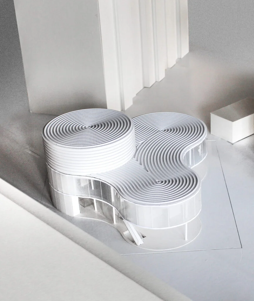 Architekturmodell – organisch geschwungene Form mit runden Fassaden in homogener, vereinfachter Darstellung.