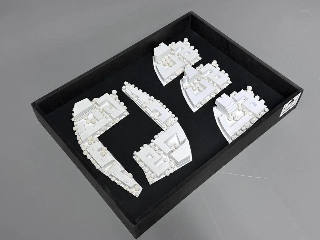 Wettbewerbsmodell 1:500 – Wohnquartier mit modularen Baukörpern in Einzelteilen, detailreich mit Bäumen.