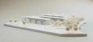 Landschaftsmodell mit zwei langgestreckten Gebäuden und dichter Baumstruktur in realistischer Präsentation