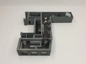 3D-Interieurmodell eines Bürogrundrisses mit Räumen, Möbeln und Arbeitsbereichen in grauer Ausführung von oben betrachtet.