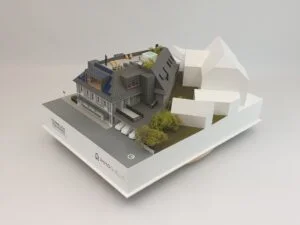 Architekturmodell einer modernen Wohnanlage mit Podest und umliegenden Gebäuden in perspektivischer Ansicht