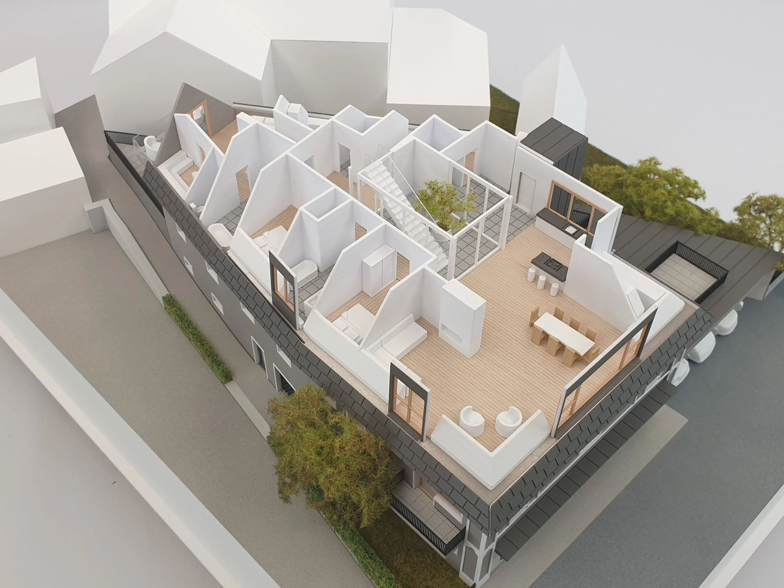 Wohnungsmodell im Dachgeschoss mit detaillierter Innenraumdarstellung, offenen Grundrissen und Terrasse.