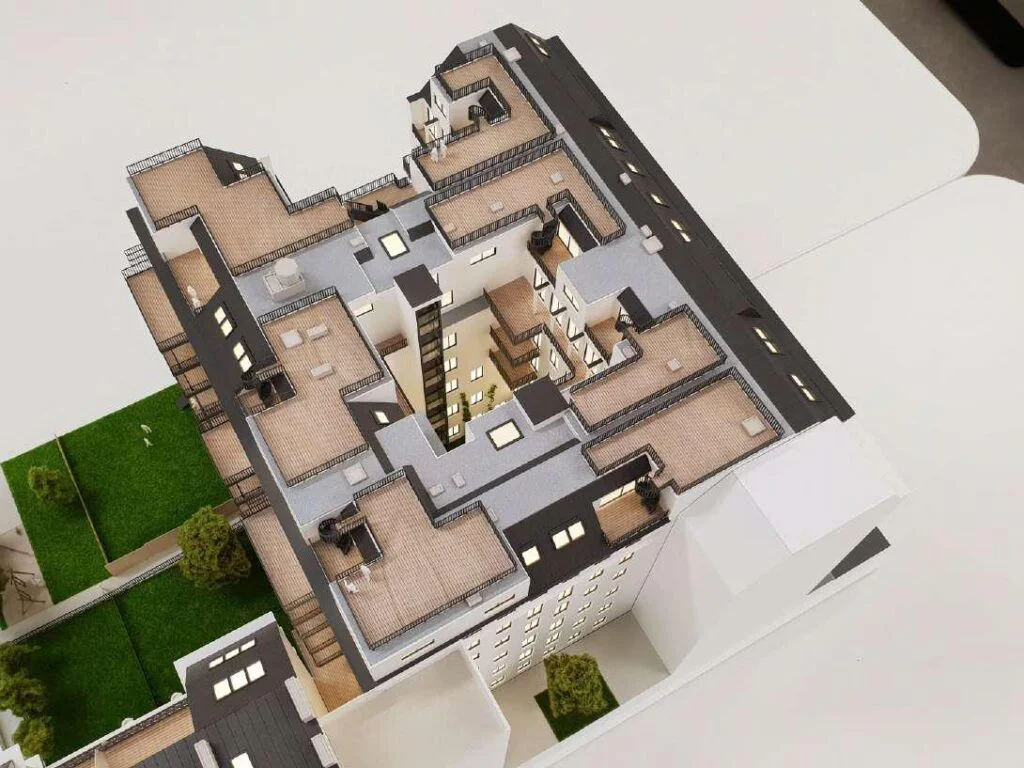 Dachterrassen und Innenhof eines detaillierten Architekturmodells mit begrünten Bereichen und modernen Gebäudestrukturen.