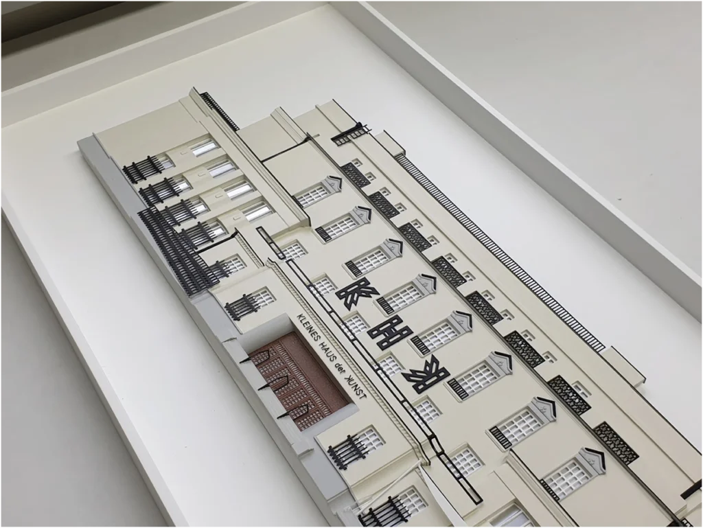 Studienmodell einer Altbau-Fassade mit Beschriftung und ausgearbeiteten Fenster- und Balkonachsen.