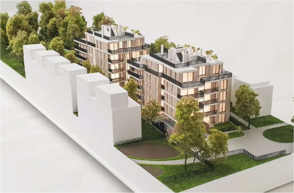 Detailliertes Architekturmodell eines modernen Wohnensembles – realistische Darstellung von Fassaden, Balkonen und Grünflächen im Maßstab 1:100
