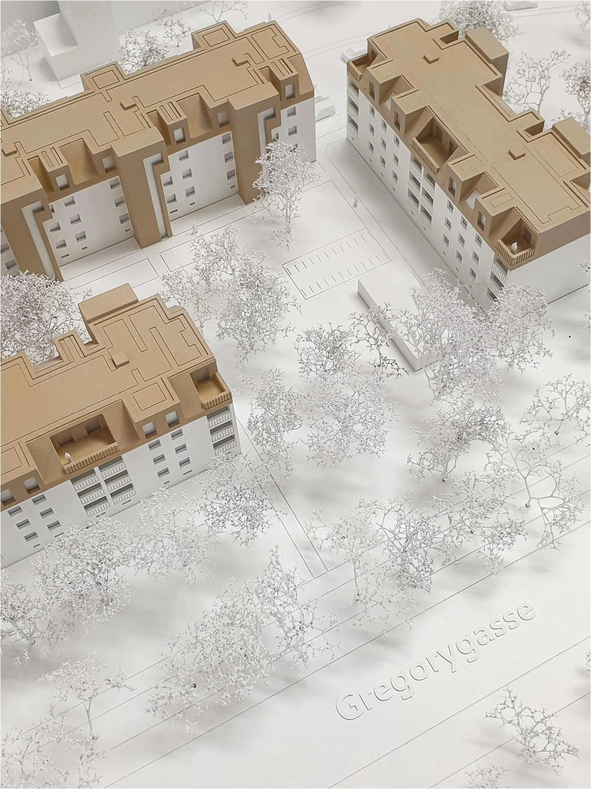 Architekturmodell einer Wohnanlage mit Straßenbeschriftung „Gregorygasse“, detaillierte Fassaden und Dachlandschaft, Stadtmodell mit Bäumen und Wegen