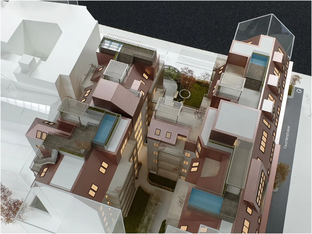 Detailansicht eines Quartiersmodells eines Wohnprojekts mit mehreren Gebäuden, Architekturmodell mit Dachterrassen, Innenhöfen und integrierter Beleuchtung