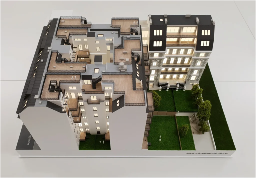 Architekturmodell eines Altbau-Wohnensembles mit Innenhof, begrünten Freiflächen und ausgebauten Dachterrassen.
